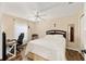 Bright bedroom with a ceiling fan, wood floors, and a cozy workspace at 16023 Sw 14Th Avenue Rd, Ocala, FL 34473