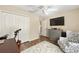 Bright bedroom featuring a large closet, TV and chair at 16023 Sw 14Th Avenue Rd, Ocala, FL 34473