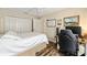 Bedroom with hardwood floors, a double closet, and an adjacent workspace at 16023 Sw 14Th Avenue Rd, Ocala, FL 34473