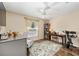 Cozy bedroom with a ceiling fan, desk, rug, and a chair at 16023 Sw 14Th Avenue Rd, Ocala, FL 34473