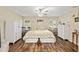 Relaxing bedroom with hardwood floors, two bright windows, and closet at 16023 Sw 14Th Avenue Rd, Ocala, FL 34473