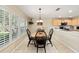 Inviting dining area with a wooden table, black chairs, and views of the kitchen at 16023 Sw 14Th Avenue Rd, Ocala, FL 34473