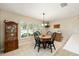 Cozy dining area featuring a wooden table, black chairs, and a large window with natural light at 16023 Sw 14Th Avenue Rd, Ocala, FL 34473