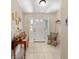 Welcoming foyer with tile flooring, rocking chair and a table to the side at 16023 Sw 14Th Avenue Rd, Ocala, FL 34473