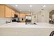 Kitchen with stainless steel appliances, light wood cabinets, tiled floors, and long countertop peninsula at 16023 Sw 14Th Avenue Rd, Ocala, FL 34473