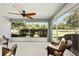 Relaxing screened lanai with comfortable seating and a ceiling fan at 16023 Sw 14Th Avenue Rd, Ocala, FL 34473