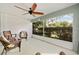 Inviting screened lanai with ample seating and a ceiling fan at 16023 Sw 14Th Avenue Rd, Ocala, FL 34473