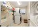 Well-organized laundry room with stacked washer/dryer and ample shelving for storage at 16023 Sw 14Th Avenue Rd, Ocala, FL 34473