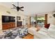 Bright living room with a ceiling fan, cozy furniture, hardwood floors and sliding door access to the lanai at 16023 Sw 14Th Avenue Rd, Ocala, FL 34473