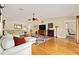 Spacious living room with hardwood floors, a floral rug, comfortable seating, and neutral wall paint at 16023 Sw 14Th Avenue Rd, Ocala, FL 34473