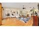 Open concept living room with hardwood floors and access to the dining room, and kitchen at 16023 Sw 14Th Avenue Rd, Ocala, FL 34473