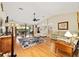 Open living room with hardwood floors, a ceiling fan, and sliding glass doors at 16023 Sw 14Th Avenue Rd, Ocala, FL 34473