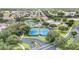 Aerial view of a neighborhood with tennis courts and lush trees surrounding the community at 16023 Sw 14Th Avenue Rd, Ocala, FL 34473