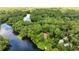 Captivating aerial view of the lakefront house, enveloped in nature and calm waters at 19620 Fox Trl, Dunnellon, FL 34432