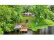 Aerial view of property, showing the house on a hill, dock, and lake at 19620 Fox Trl, Dunnellon, FL 34432