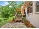 Back deck and stairs with an umbrella at 19620 Fox Trl, Dunnellon, FL 34432