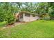 Exterior of home with lush backyard and wooden deck at 19620 Fox Trl, Dunnellon, FL 34432