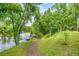 Scenic backyard view with a pathway leading to a dock on the calm river at 19620 Fox Trl, Dunnellon, FL 34432