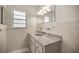 Clean bathroom with a vanity, mirror, and tiled walls at 19620 Fox Trl, Dunnellon, FL 34432