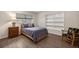 Cozy bedroom with wood floors, and a window providing natural light at 19620 Fox Trl, Dunnellon, FL 34432