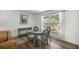 Cozy dining area with a view to the backyard through a large window at 19620 Fox Trl, Dunnellon, FL 34432