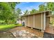 Exterior of storage building, connecting to house, with paver sidewalk and utility hookups at 19620 Fox Trl, Dunnellon, FL 34432