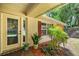 Inviting front porch with stylish door, lovely plants, and charming curb appeal at 19620 Fox Trl, Dunnellon, FL 34432