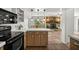 Open kitchen with modern appliances, island, and view to the living room at 19620 Fox Trl, Dunnellon, FL 34432