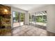 Living room with stone fireplace and sliding glass doors to the outdoor spaces at 19620 Fox Trl, Dunnellon, FL 34432