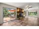 Open living room with fireplace, tile floors, and access to a deck with views of the water at 19620 Fox Trl, Dunnellon, FL 34432