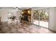 Spacious living room with stone fireplace, tile floors, and access to outdoor deck with river views at 19620 Fox Trl, Dunnellon, FL 34432