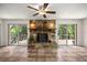 Living room with stunning stone fireplace and sliding glass doors to the deck at 19620 Fox Trl, Dunnellon, FL 34432