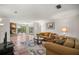 Open-concept living room with stone fireplace and sliding glass doors to the backyard deck at 19620 Fox Trl, Dunnellon, FL 34432