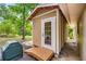 Exterior view of shed featuring wood door, ramp, and siding matching the main house at 19620 Fox Trl, Dunnellon, FL 34432