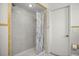 Shower with glass door and grey stone-look tile at 19620 Fox Trl, Dunnellon, FL 34432