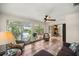 Cozy sunroom with comfortable seating, tile floors, and large windows offering serene water views at 19620 Fox Trl, Dunnellon, FL 34432