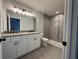 Modern bathroom with a double granite vanity and a tiled walk-in shower at 19990 Sw 75Th St, Dunnellon, FL 34431