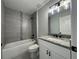 Bathroom showcasing a bathtub with tiled walls and a modern vanity with a granite countertop at 19990 Sw 75Th St, Dunnellon, FL 34431