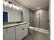Modern bathroom with a double granite vanity and a tiled walk-in shower at 19990 Sw 75Th St, Dunnellon, FL 34431
