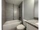 Bathroom showcasing a bathtub with tiled walls and a modern vanity with a granite countertop at 19990 Sw 75Th St, Dunnellon, FL 34431