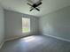 Bedroom features gray tile flooring and a window that brings in natural light from the outdoors at 19990 Sw 75Th St, Dunnellon, FL 34431