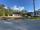 New construction home featuring concrete block walls and a concrete roof, set against a blue sky with white clouds at 19990 Sw 75Th St, Dunnellon, FL 34431