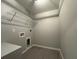 Laundry room with tile flooring, wire rack and gray walls at 19990 Sw 75Th St, Dunnellon, FL 34431