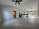 Open-concept living space features vaulted ceilings, gray tile flooring, and a kitchen island with modern appliances at 19990 Sw 75Th St, Dunnellon, FL 34431
