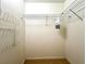 Walk in closet featuring white walls and metal storage racks with an empty floor space at 2100 Nw 50Th Cir, Ocala, FL 34482
