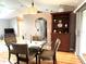 Well-lit dining area with glass table, upholstered chairs, and a charming wood display cabinet at 2100 Nw 50Th Cir, Ocala, FL 34482