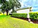 Well-maintained exterior with lush landscaping and mature trees, providing shade and curb appeal to the property at 2100 Nw 50Th Cir, Ocala, FL 34482