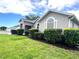 Well-maintained home exterior with lush green lawn and trimmed landscaping at 2100 Nw 50Th Cir, Ocala, FL 34482