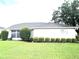 Charming single-story home with a well-manicured lawn and mature landscaping, featuring a neutral color palette at 2100 Nw 50Th Cir, Ocala, FL 34482