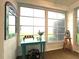 Inviting Florida room with table, chairs and view of the outdoors through abundant windows at 2100 Nw 50Th Cir, Ocala, FL 34482